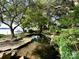 Beautiful pond with a koi fish, rock features, lush landscaping, and serene waterfront views at 7794 Live Oaks Dr, Denver, NC 28037