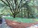 Mature trees and lush green ground cover create a beautiful backyard space at 7794 Live Oaks Dr, Denver, NC 28037