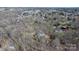 Aerial view of a neighborhood featuring a single Gathering home nestled among trees at 8125 Appaloosa Ln, Charlotte, NC 28215