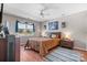 Comfortable bedroom with a ceiling fan, a large window, wood-look floors, and a queen-sized bed at 8125 Appaloosa Ln, Charlotte, NC 28215
