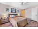 Stylish bedroom with a queen-sized bed, wood-look flooring, a barn door, and neutral decor at 8125 Appaloosa Ln, Charlotte, NC 28215