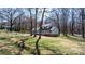 View of a charming two-story home surrounded by trees and a well-maintained lawn at 8125 Appaloosa Ln, Charlotte, NC 28215