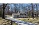 Classic two-story home with a long driveway and mature trees at 8125 Appaloosa Ln, Charlotte, NC 28215