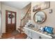Bright foyer featuring wood floors, wooden stairs, and an accent table at 8125 Appaloosa Ln, Charlotte, NC 28215