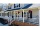 Inviting front porch with white railings and hanging floral baskets at 8125 Appaloosa Ln, Charlotte, NC 28215