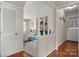 Hallway with wood floors and a view into the living room with a fireplace at 8125 Appaloosa Ln, Charlotte, NC 28215