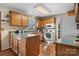 Traditional kitchen featuring wood cabinets, white appliances, and hardwood floors at 8125 Appaloosa Ln, Charlotte, NC 28215