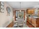 Eat-in kitchen featuring wood cabinets, natural lighting, and round dining table at 8125 Appaloosa Ln, Charlotte, NC 28215