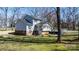 Home's rear exterior features a deck, sunroom, and access to the backyard at 8125 Appaloosa Ln, Charlotte, NC 28215