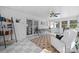 Bright sunroom featuring tile floors, a ceiling fan, a seating area, and sliding glass doors to the outdoors at 8125 Appaloosa Ln, Charlotte, NC 28215