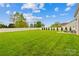 A large, well-maintained backyard enclosed by a white fence, with meticulously arranged greenery at 963 Brookdale Ln, Stanley, NC 28164