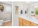 Well-lit bathroom featuring a white vanity, neutral walls, and decorative accents at 963 Brookdale Ln, Stanley, NC 28164