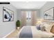 Comfortable bedroom with natural light, neutral tones, and decorative artwork at 963 Brookdale Ln, Stanley, NC 28164