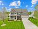 Beautiful two-story home with manicured lawn, stone accents, and an attached two-car garage at 963 Brookdale Ln, Stanley, NC 28164