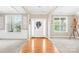 Inviting foyer with hardwood floors, decorative columns, and abundant natural light through large windows at 963 Brookdale Ln, Stanley, NC 28164