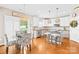 Eat-in kitchen with hardwood floors, kitchen island, stainless appliances and backyard view at 963 Brookdale Ln, Stanley, NC 28164