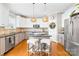 Kitchen features a center island with barstool seating and stainless appliances at 963 Brookdale Ln, Stanley, NC 28164