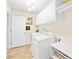 Well-lit laundry room with a washer, a dryer, white cabinetry, and tiled floors at 963 Brookdale Ln, Stanley, NC 28164