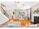 Bright living room with a fireplace, hardwood floors, and a ceiling fan at 963 Brookdale Ln, Stanley, NC 28164
