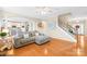 Open-concept living room featuring hardwood floors, staircase and modern décor at 963 Brookdale Ln, Stanley, NC 28164