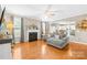 Open living room featuring a fireplace, hardwood floors, and a view into the kitchen at 963 Brookdale Ln, Stanley, NC 28164