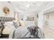 Comfortable main bedroom featuring a tray ceiling, soft lighting, and a stylish dresser with a TV at 963 Brookdale Ln, Stanley, NC 28164