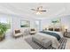 Stylishly staged main bedroom showcasing a trey ceiling, a ceiling fan, and plush seating at 963 Brookdale Ln, Stanley, NC 28164