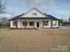 Beautiful white single-story home boasts charming wooden shutters and a welcoming front porch with stylish columns at 0000 Trull Hinson Rd # 2, Wingate, NC 28174