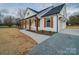 Elegant white home featuring a covered porch with wood columns and shutters, complemented by a well-manicured lawn at 0000 Trull Hinson Rd # 2, Wingate, NC 28174
