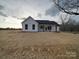Charming single-story home with a covered front porch, and a spacious, unfinished front yard at 0000 Trull Hinson Rd # 2, Wingate, NC 28174
