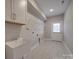 Functional laundry room with a utility sink, storage cabinets, and a convenient exterior access door at 0000 Trull Hinson Rd # 2, Wingate, NC 28174