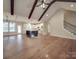 Open-concept living space with vaulted ceilings, exposed beams, hardwood floors, and a modern kitchen with an island at 0000 Trull Hinson Rd # 2, Wingate, NC 28174