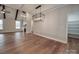 Well-lit living room and dining area featuring vaulted ceilings, hardwood floors, and a stylish chandelier at 0000 Trull Hinson Rd # 2, Wingate, NC 28174