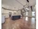 Spacious living room and kitchen with hardwood floors, a large island, white cabinets, and an open floor plan at 0000 Trull Hinson Rd # 2, Wingate, NC 28174