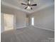 Large main bedroom with a tray ceiling, plush carpet, and private access to an ensuite bathroom at 0000 Trull Hinson Rd # 2, Wingate, NC 28174