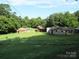 Backyard with multiple structures on the property, including mobile homes and single-Gathering homes, needs TLC at 1000 Jl Tyson Dr, Gastonia, NC 28056
