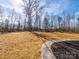 Expansive backyard featuring a wooded area and professionally landscaped with mulch at 1022 Harrogate Dr, Bessemer City, NC 28016