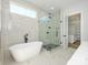 Bathroom featuring a standalone tub and a glass enclosed shower at 1022 Harrogate Dr, Bessemer City, NC 28016