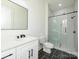 Bathroom featuring a vanity sink with black hardware and a glass-enclosed shower at 1022 Harrogate Dr, Bessemer City, NC 28016