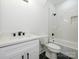 Bathroom featuring a single vanity sink with black hardware and a tiled tub and shower at 1022 Harrogate Dr, Bessemer City, NC 28016