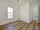 Bedroom with hardwood floors, a window with a view, and a double-door closet at 1022 Harrogate Dr, Bessemer City, NC 28016