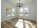 Bright dining room with wood floors and a decorative chandelier at 1022 Harrogate Dr, Bessemer City, NC 28016