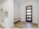 Inviting entryway featuring a bench and modern door, providing a seamless transition into the home at 1022 Harrogate Dr, Bessemer City, NC 28016