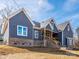 Exterior of home showcasing its architectural details, gray siding, and professional landscaping at 1022 Harrogate Dr, Bessemer City, NC 28016