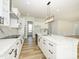 Modern kitchen featuring a large island, white cabinets, and stainless steel appliances at 1022 Harrogate Dr, Bessemer City, NC 28016