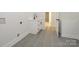 Laundry room with gray floors, a utility sink, and access to other rooms at 1022 Harrogate Dr, Bessemer City, NC 28016