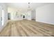 Open concept living room featuring wood floors and bright white walls at 1022 Harrogate Dr, Bessemer City, NC 28016