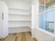 Well-organized pantry with ample shelving and storage space, adjacent to a bright window at 1022 Harrogate Dr, Bessemer City, NC 28016