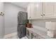 Efficient laundry room boasts stacked washer and dryer, storage cabinets, and ample counter space at 10400 Tyne Ct, Charlotte, NC 28210