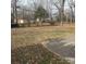 Spacious backyard featuring a concrete patio area surrounded by mature trees and foliage at 1111 Pondella Dr # 66, Charlotte, NC 28213